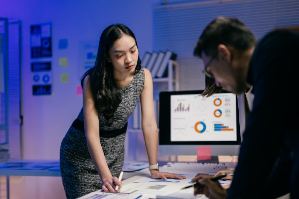 Business team analyzing data late at night